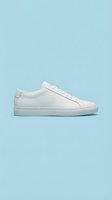 White minimalist leather low-top sneaker on a light blue background, showcasing clean design and casual style for fashion and footwear advertising.