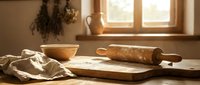 Rustic kitchen scene with wooden rolling pin and flour on cutting board in warm sunlight streaming through window creating cozy baking atmosphere.