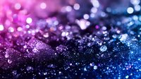 Sparkling glitter background with gradient from pink to blue colors, macro shot showing detailed texture of shimmering particles and bokeh light effects.