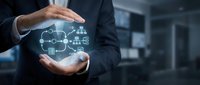 Businessman hands protecting cloud computing network with connected devices and data storage technology in modern office environment.