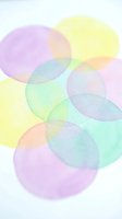 Abstract watercolor circles in soft pastel colors overlapping on white background creating dreamy translucent effect for modern design projects.