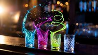 Colorful cocktail glasses with neon liquid splashes creating dynamic light trails against blurred bar background for nightlife and party concepts.