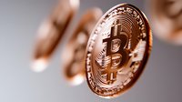 Copper-colored cryptocurrency coin with bitcoin symbol shown in macro detail against blurred background, highlighting digital currency concept and financial technology.
