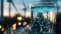 Sparkling mineral water with blue bubbles in glass against blurred evening city lights and bokeh background, refreshing summer drink concept.