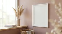 Blank white frame mockup on pink wall with pampas grass vase and wicker chair in modern minimalist interior for artwork display and home decor design.