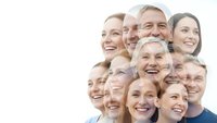 Happy diverse group of smiling people faces clustered together showing joy and positivity on white background for community and teamwork concepts.