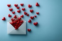 Red hearts spilling out from white envelope on blue background, symbolizing love message, romantic correspondence, or Valentine's Day greeting card concept.