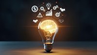 Glowing light bulb with brain inside surrounded by business icons on dark background representing innovation, creativity and strategic thinking concepts.