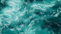 Swirling turquoise ocean waves create abstract patterns with white foam and dynamic water movement, capturing nature's fluid artistry in mesmerizing aqua tones.