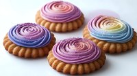 Colorful rainbow frosted cupcakes with swirled icing on golden pastry bases, perfect for bakery displays, dessert menus, and sweet treat marketing materials.