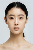 Young Asian woman with natural makeup and clear glowing skin on white background, front view portrait showing minimalist beauty and skincare concept.