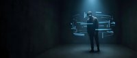 Businessman in formal suit interacting with holographic digital interface and data visualization in dark futuristic environment for technology and innovation concepts.