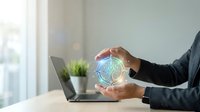 Professional businessman holding glowing digital brain hologram above hands in modern office workspace representing artificial intelligence and innovation.
