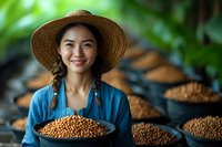 Young Asian woman in straw hat and blue dress holding fresh coffee beans at plantation, with drying beans in background, natural light and authentic setting.
