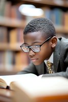 Young African American student wearing glasses reads intently in library, dressed in business attire. Close-up portrait shows focused concentration and academic dedication.