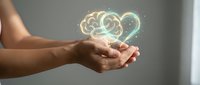 Person holding glowing brain and heart symbol, representing mental health, emotional intelligence, mindfulness and wellness concept for healthcare and psychology.