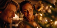 Young couple enjoying festive holiday atmosphere with warm Christmas lights and decorations, creating intimate romantic moment.