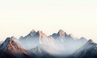 Majestic mountain peaks bathed in soft morning light, creating dramatic silhouettes against misty atmosphere. Serene alpine landscape with snow-dusted summits at sunrise.