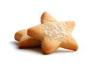 Star-shaped sugar cookie with sprinkled coarse sugar crystals on top, isolated on white background for easy design integration and commercial food photography.
