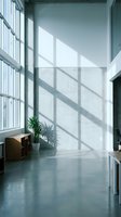 Modern minimalist interior with large windows casting geometric shadows on white walls and polished concrete floors in contemporary office space.