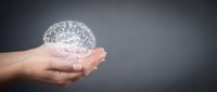 Human hands holding glowing transparent brain hologram against dark background for mental health, neuroscience and cognitive psychology concepts.