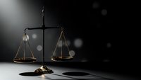 Golden scales of justice on dark background with dramatic lighting and bokeh effects for legal concepts and law firm branding.