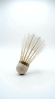 Badminton shuttlecock with white feathers and cork base isolated on white background, ready for sports and recreation design projects.