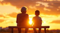 Silhouette of grandmother and grandson sitting on bench watching dramatic orange sunset sky, sharing peaceful moment together at dusk.