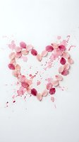 Pink flower petals arranged in heart shape with watercolor splashes on white background for romantic design projects.