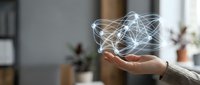 Hand holding glowing network connections representing digital technology, artificial intelligence, and data connectivity in modern workspace.