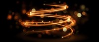 Golden spiral light trail with glowing particles and bokeh effects on dark background for motion graphics and digital art projects.