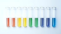 Laboratory test tubes with colorful liquids arranged in row for scientific research and chemical analysis experiments in medical facility.