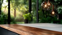 Modern pendant lights with glowing bulbs hanging over wooden table against blurred green forest background, creating cozy atmospheric interior design setting.