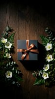 Elegant black gift box with copper ribbon surrounded by white flowers and green foliage on rustic wooden background for special occasions and celebrations.