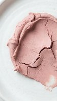 Crushed rose powder with cracked texture on white surface, suitable for cosmetics, makeup, beauty products, and skincare packaging design.