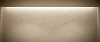 Modern minimalist interior wall with subtle geometric pattern and soft ambient lighting creating elegant shadows and depth.