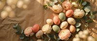 Elegant floral arrangement with soft pastel roses and eucalyptus leaves on warm textured background for wedding decor and romantic celebrations.