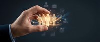 Businessman hand holding glowing light bulb with digital particles and network connections, representing innovation, ideas, and technology solutions for business growth.