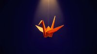 Orange origami paper crane hanging from string against dark blue background with dramatic lighting for meditation and mindfulness concepts.