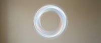 Glowing neon circle with soft white and blue light effect on neutral background, isolated for design projects and digital overlays.