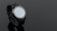 Modern black smartwatch with blank white screen display isolated on dark background for technology and wearable device mockup presentations.