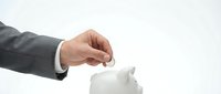 Businessman in suit inserting coin into white piggy bank for savings and investment planning on clean background.