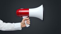 Hand holding red and white megaphone against dark background, representing announcement, communication, marketing message, promotion, and business advertising concept.