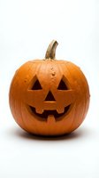 Carved orange pumpkin jack-o-lantern with smiling face isolated on white background for Halloween decorations and autumn seasonal designs.
