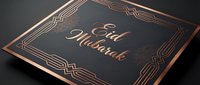 Elegant Eid Mubarak greeting card with copper foil lettering on dark background featuring art deco geometric border design for Islamic holiday celebration.