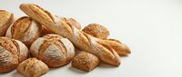 Freshly baked artisan bread rolls with golden-brown crusty exterior and scored tops arranged on white background for bakery, food, and culinary projects.