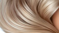 Luxurious blonde hair waves with smooth silky texture and natural highlights flowing in gentle curves against neutral background, showcasing professional hair styling.