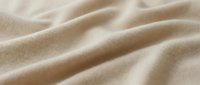 Beige linen fabric with soft folds and natural texture, suitable for textile, fashion, and interior design projects.