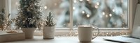 Cozy winter morning scene with coffee mug, miniature Christmas trees and warm bokeh lights by frosted window creating peaceful holiday atmosphere at home.