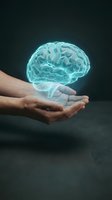 Glowing blue brain hologram floating above open human hands against dark background for mental health, neuroscience and artificial intelligence concepts.